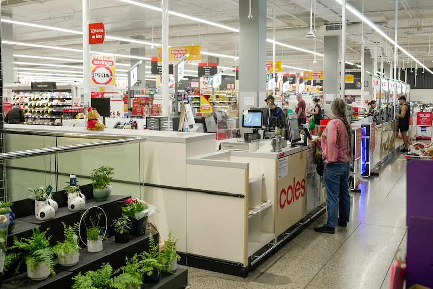Wide shot of registers at a Coles Supermarket.