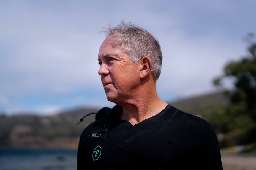 Man looks out to the ocean