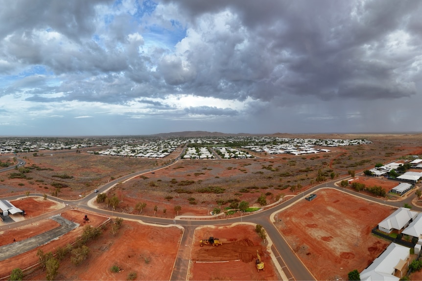 drone shot of town and dark clouds