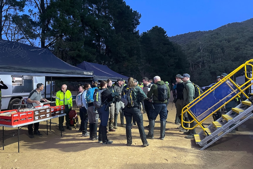 Police and other specialist units standing around preparing for the day ahead.