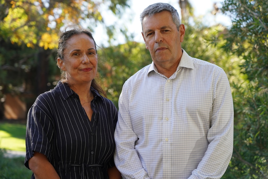 A woman and man attending a memorial service.  