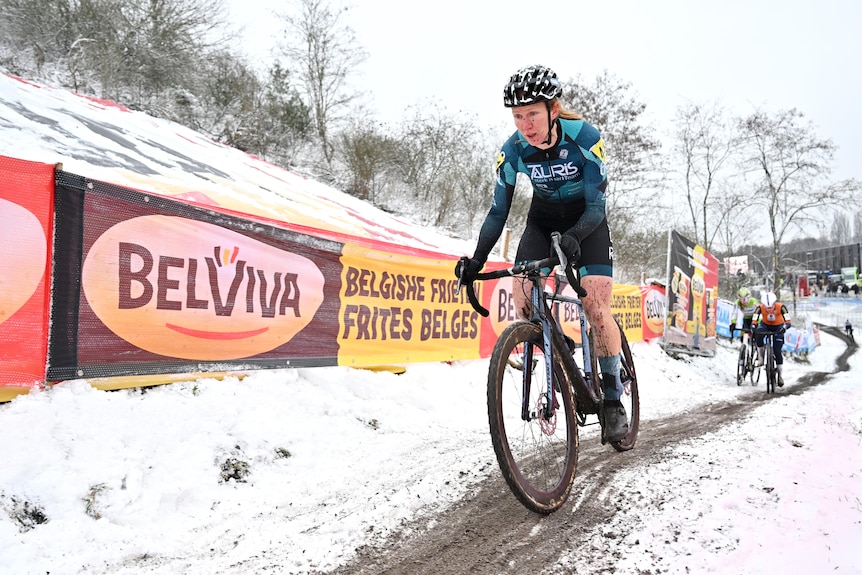 Kim van de Steene rides a bike in the snow