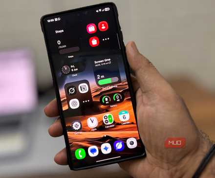 Man's hand holding a Samsung Galaxy phone showing the Home screen