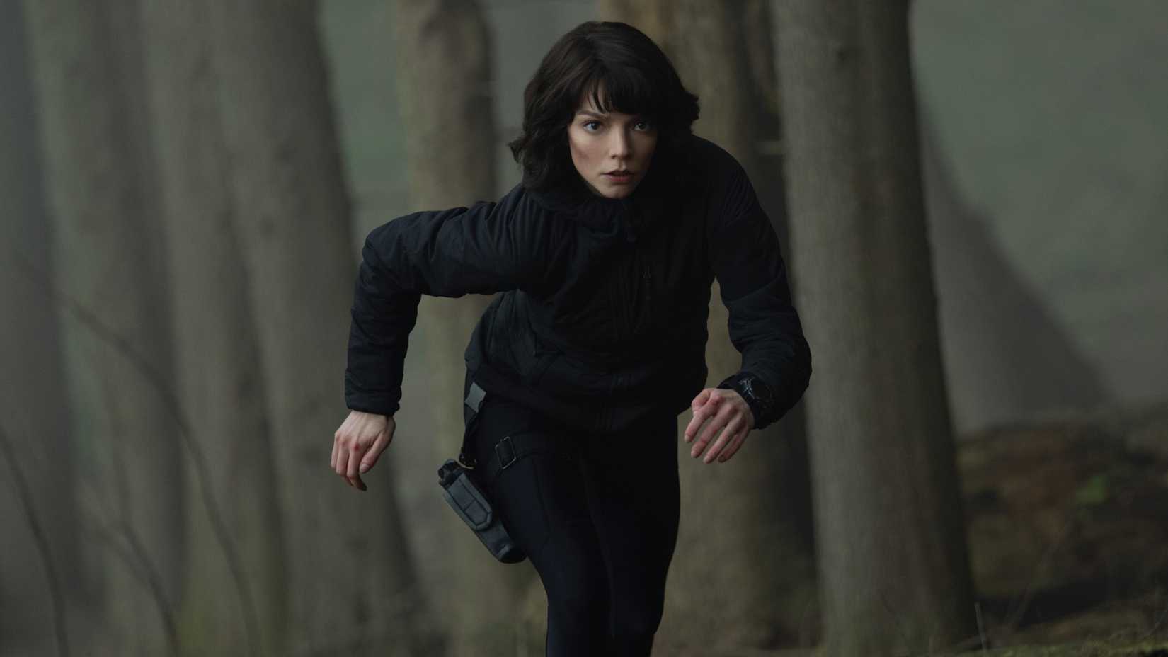 Anya Taylor-Joy running in the woods in The Gorge