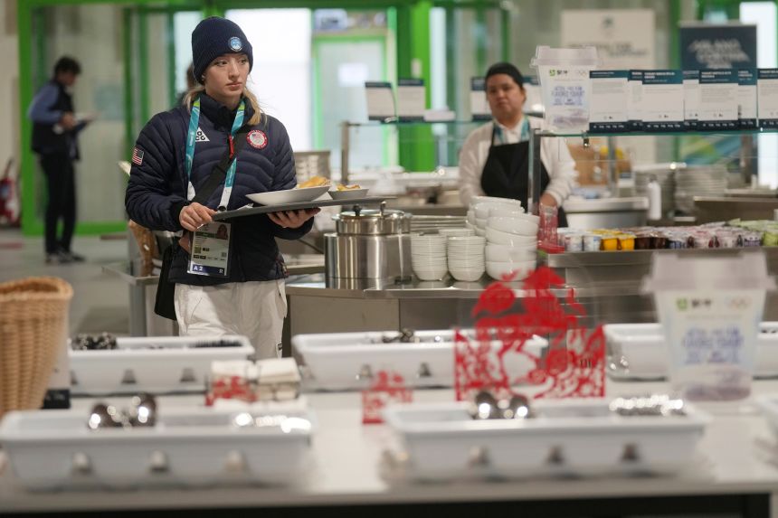 Team USA’s Amber Glenn selects breakfast items at the dining hall inside the Olympic Village in Milan, Italy, on February 3.