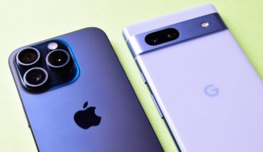 A close up of the back of an iPhone, next to the back of a Google Pixel phone, both lying on a surface.