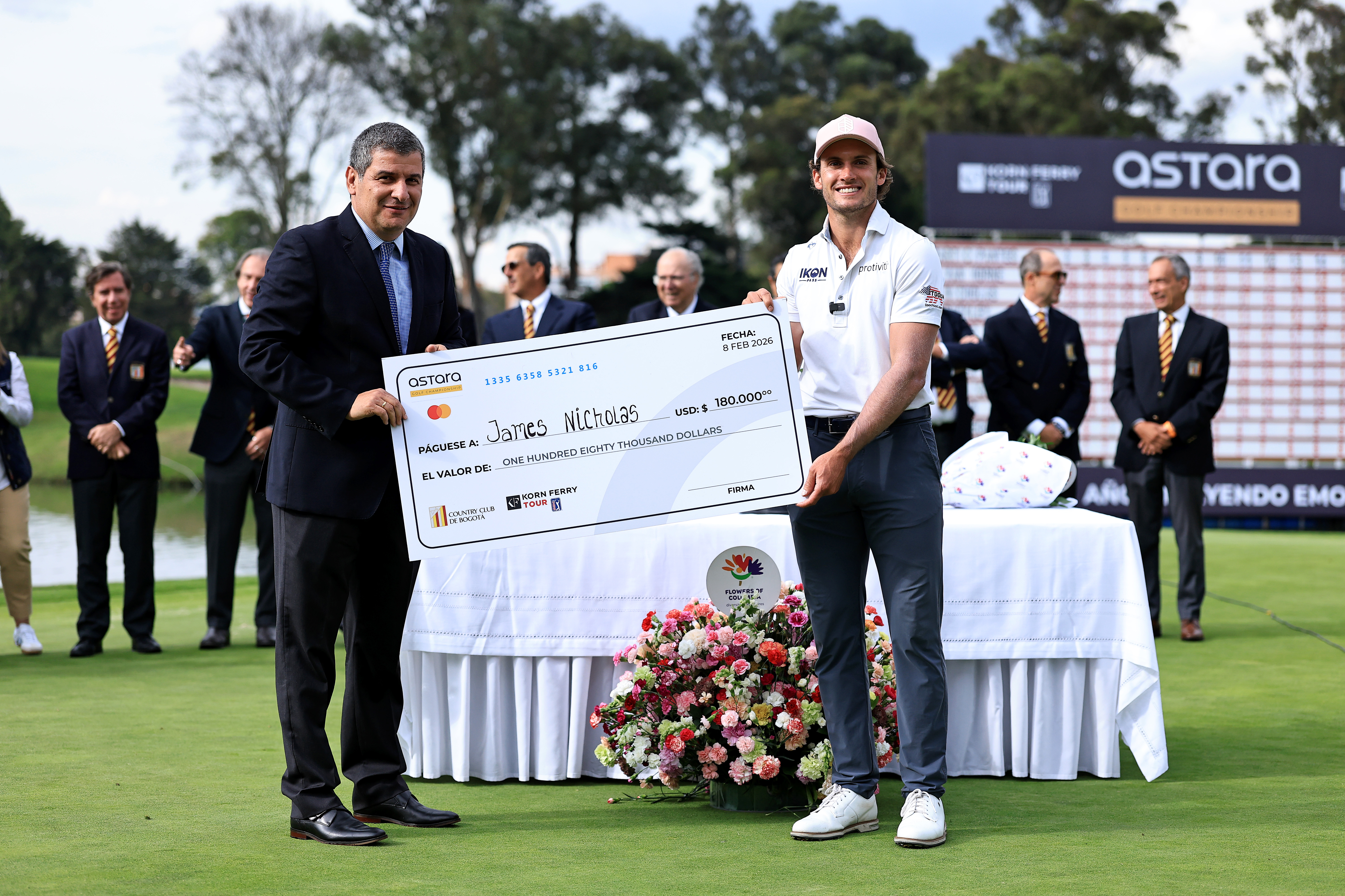 James Nicholas poses with the winner's check after claiming the Astara Golf Championship title in 2026