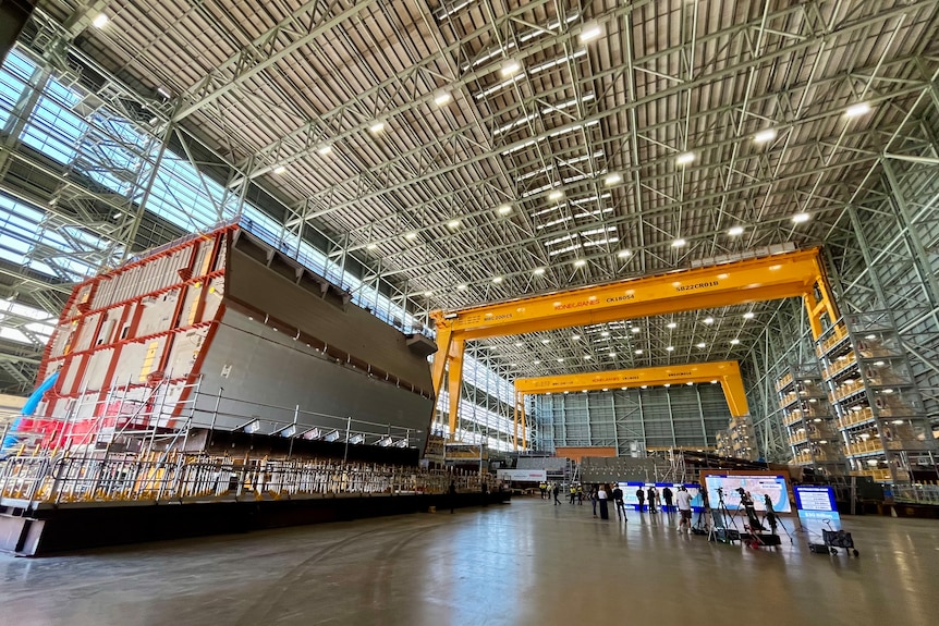 A hall with a high ceiling, industrial equipment and microphones