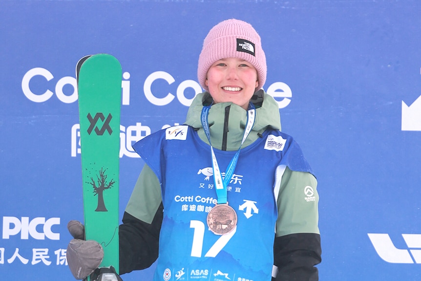 Indra Brown stands on the podium