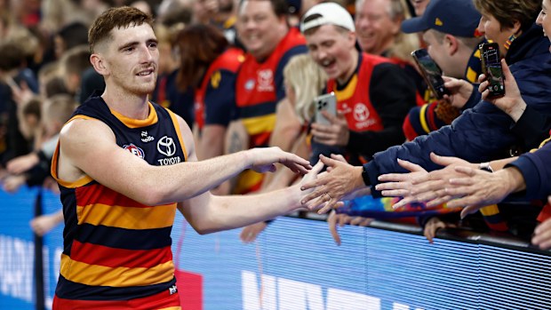 Crows defender Mark Keane shares a moment with fans following Adelaide's round 18 clash against the Bulldogs in 2025.