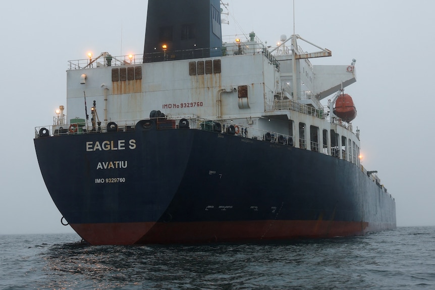 back of a large navy blue oil tanker that reads eagle s in white lettering