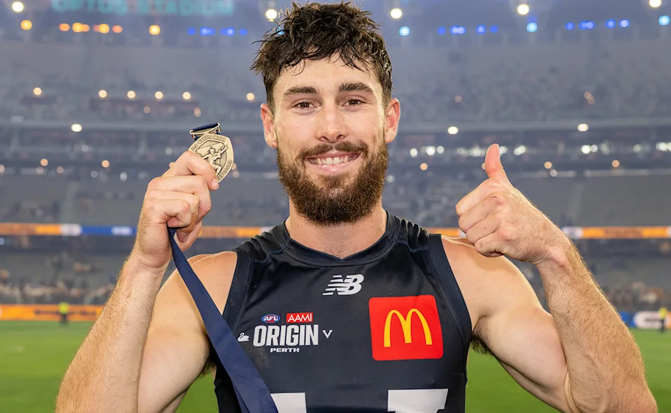 Lachie Ash with the EJ Whitten Medal.