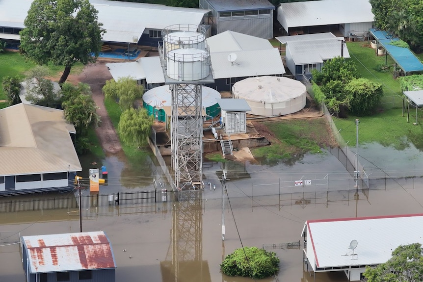 Floodwaters in the street begin to approach nearby buildings.