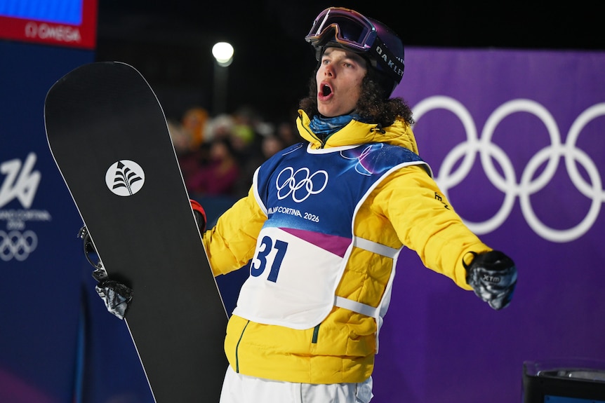 Valentino Guseli reacts during snowboard big air final at 2026 Winter Olympics.