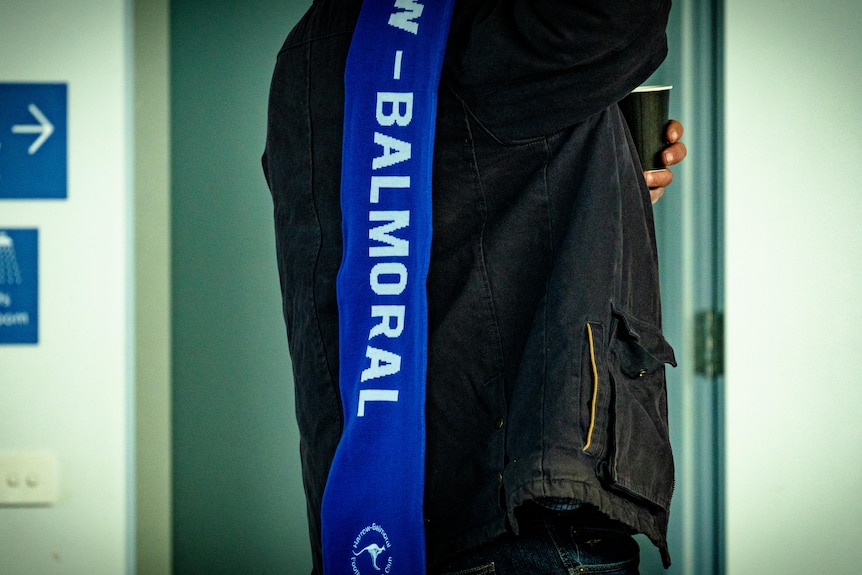 A man wears a Balmoral scarf.