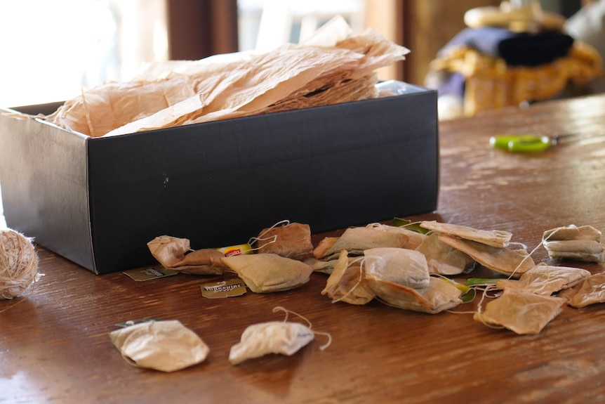 A close of box with teabags in front of it