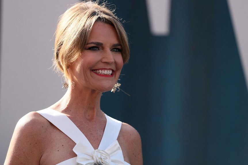 A close up of Savannah Guthrie wearing a white dress at the Vanity Fair Oscar Party.