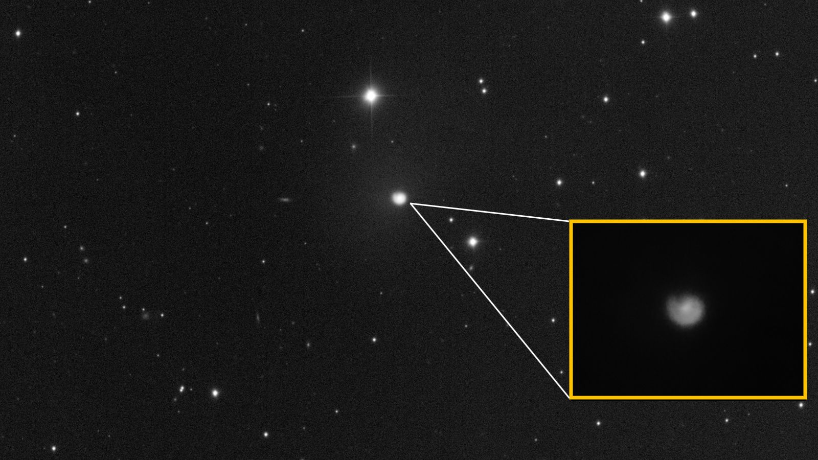 Photo of comet with a close-up of its coma showing off a distinctive spiral shape