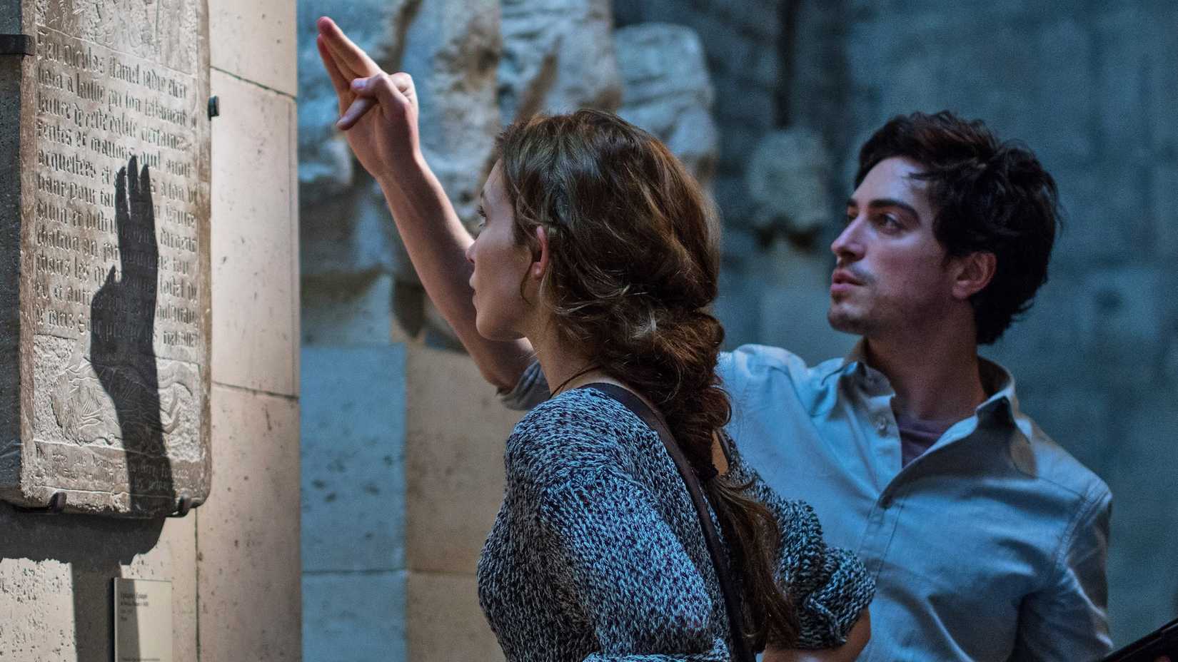 Ben Feldman and Perdita Weeks look at a stone tablet in As Above So Below