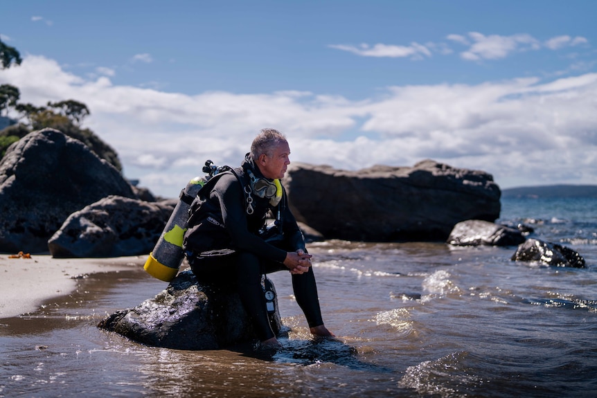 Man sits and reflects at the beach