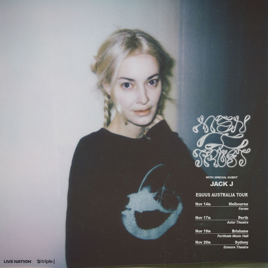 A pale woman in a black jumper with her blonde hair in plaits looks at the camera with white text next to her