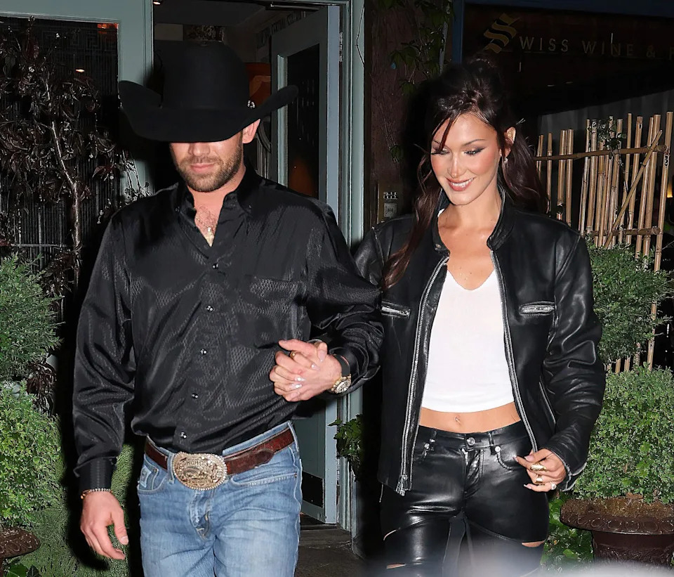 Bella Hadid holds hands with her boyfriend Adan Banuelos as they leave her Orabella party