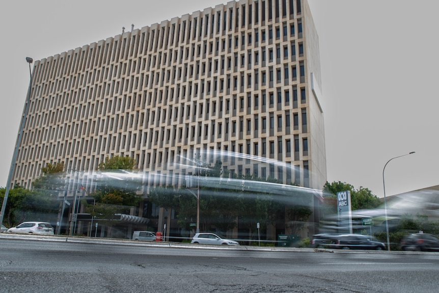 A large biege office building about five storeys tall