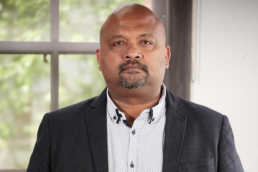A basic portrait photo of Henry Rajendra looking into the camera with a serious expression.