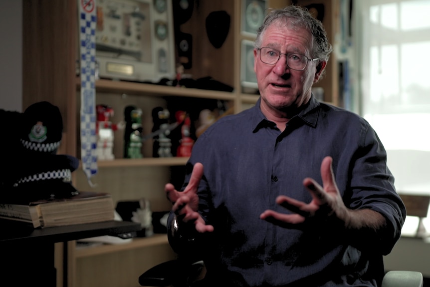 Vince Hurley sits in an office chair and speaks with his hands emphasising his point.