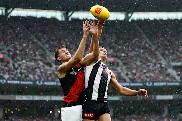 Zach Reid and Dan Houston clash in front of more than 90,000 at the MCG on Anzac Day.