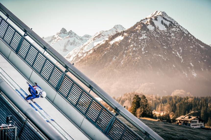 Niklas Malacinski skis down a ski jump