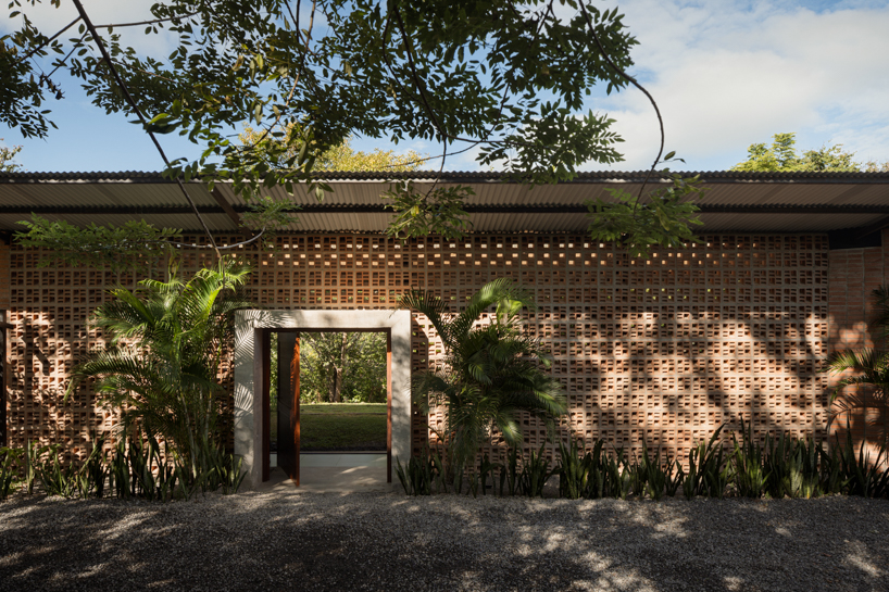 a series of porous brick partitions enclose central garden within costa rica residence