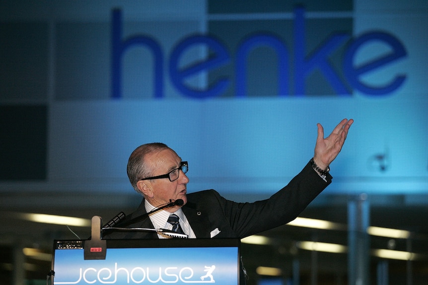 Geoff Henke gestures at a podium