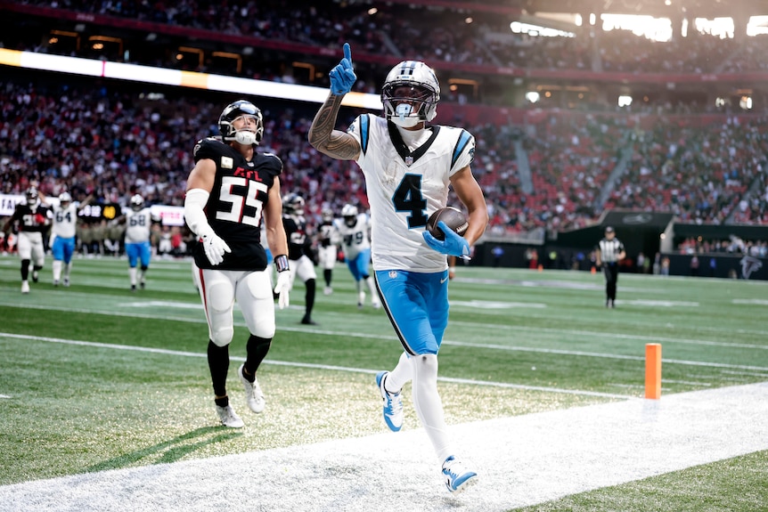 A man celebrates a touchdown during an NFL match