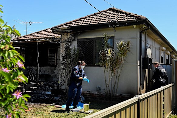 NSW Police forensic officers process the crime scene established on Hunt Street in Guilford West after a car and residential house was impacted by fire. A crime gang has declared war on the son of ex-NRL star Matt Utai.