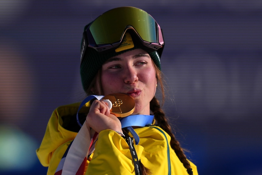 Gold medalist Josie Baff of Australia kisses her medal during the medal ceremony.