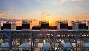 Data center cooling units at sunset, highlighting the energy and water footprint behind today’s AI boom