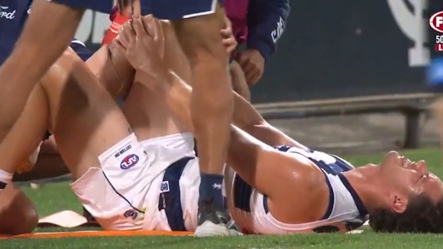 Shannon Neale holding his knee in pain.