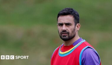 Alex Lozowski wearing a purple top and a red bib on training duty with England
