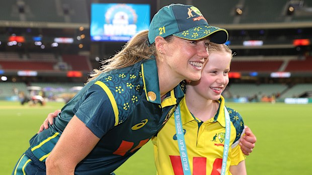 Ellyse Perry of Australia with a young fan after the game.