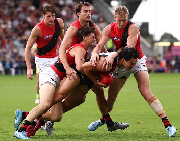 That’s trouble: Saint Mitch Owens is tackled by multiple Bombers on Saturday.