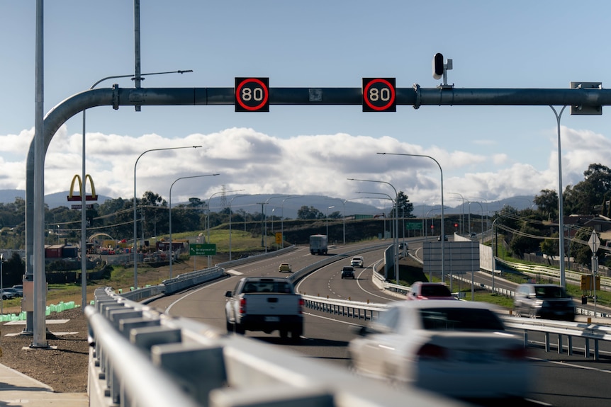 Cars driving over a bridge.