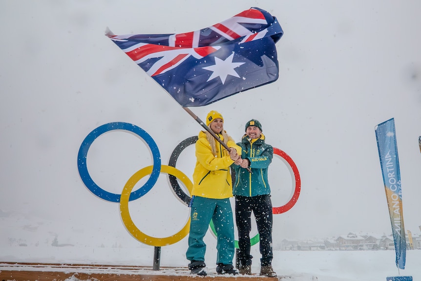 Dani Scott and Cooper Woods wave an Australian flag