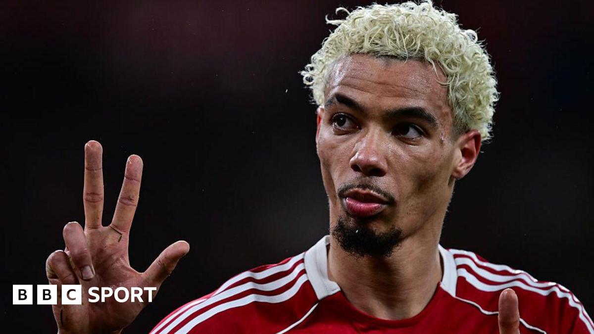 Hugo Ekitike gestures the score to Newcastle fans at Anfield