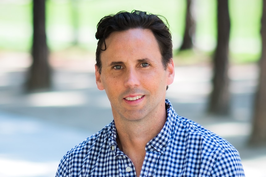 man smiles at camera, portrait