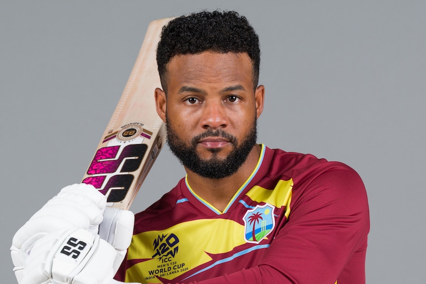 Shai Hope holds up a cricket bat
