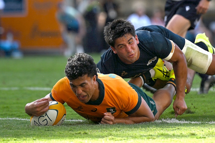 Joseph-Aukuso Suaalii of the Wallabies scoring in a dive across the line,