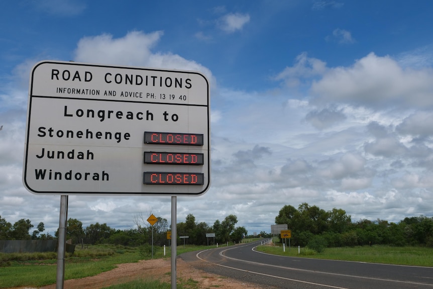 A sign in western Queensland notifying motorists that roads are closed due to flooding.