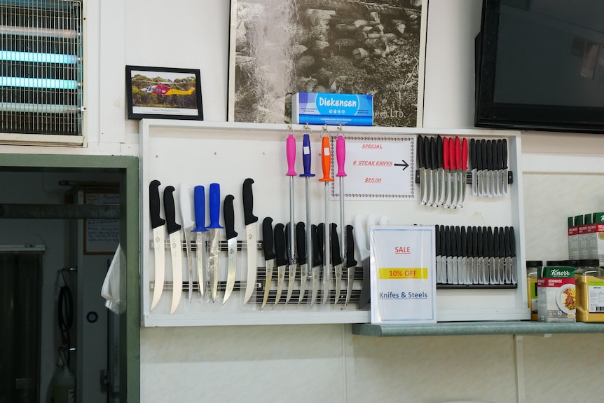 Butchers knives and sharpeners hung up on a wall inside Mornington Butchery.