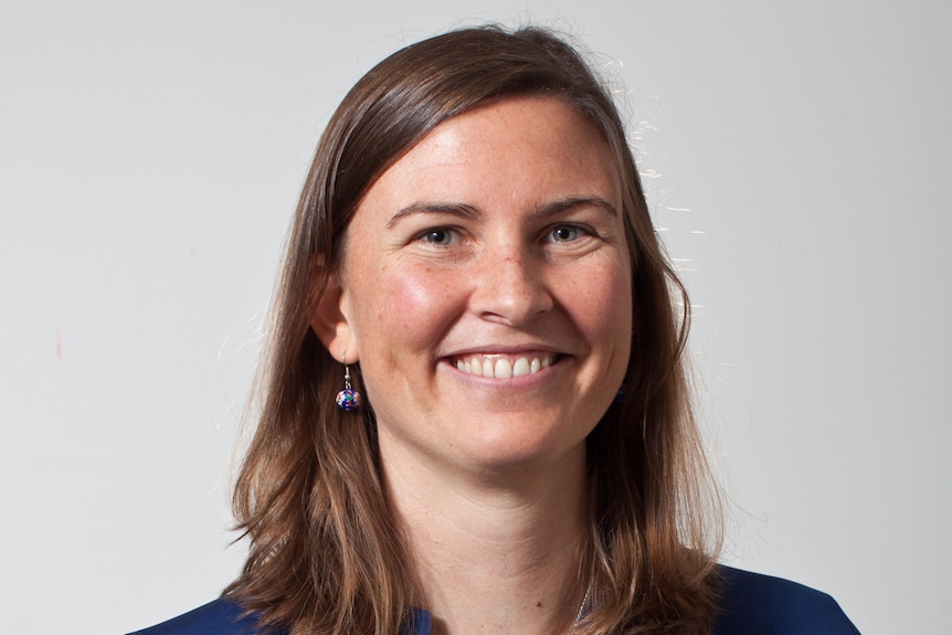 Headshot of woman with brown hair, smiling